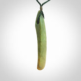 This is a lovely, large, New Zealand Flower Jade, pounamu drop pendant. Hand carved for us by Ric Moor. It is bound with an adjustable manuka green coloured cord which is length adjustable.